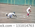 A runner slides into home plate during a passed ball 131014763