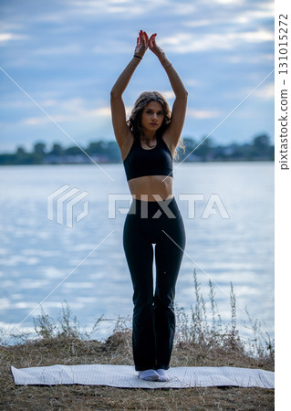 Enjoy a refreshing Outdoor Yoga Practice by the Water in a tranquil setting for mindfulness Enjoy a refreshing Outdoor Yoga Practice by the Water in a tranquil setting for mindfulness 131015272
