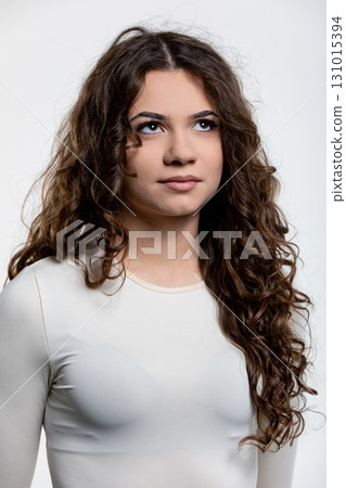 A Beautiful Portrait of a Young Woman with Curly Hair Depicted in a Minimalist Style A Beautiful Portrait of a Young Woman with Curly Hair Depicted in a Minimalist Style 131015394