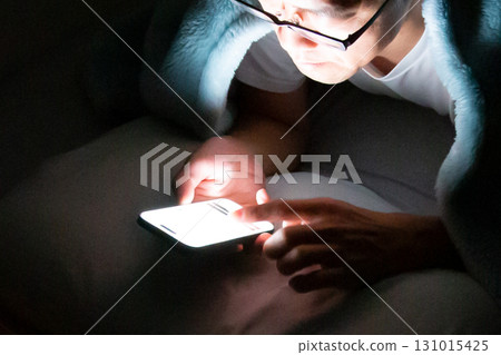 People who use and operate their smartphones in bed before going to sleep People who use and operate their smartphones in bed before going to sleep 131015425