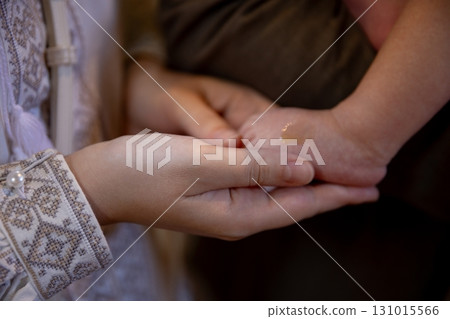 Tender Moment An Adult Hand Gently Holding A Childs Small Hand in a Loving Gesture 131015566