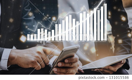 Businessman using smartphone and tablet technology with data visualization charts representing growth and success in financial market analysis and strategy Copula 131015586