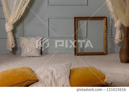 An Elegant and Cozy Interior Space Featuring a Decorative Frame Alongside Cushions An Elegant and Cozy Interior Space Featuring a Decorative Frame Alongside Cushions 131015616