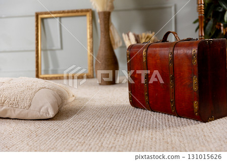 A vintage travel suitcase combined with cozy decor creates an inviting stylish setting A vintage travel suitcase combined with cozy decor creates an inviting stylish setting 131015626
