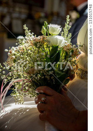 An Elegant and Exquisite Bridal Bouquet Featuring Lovely Roses and Delicate Babys Breath 131015748