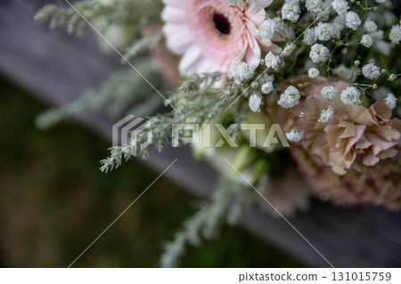 A Delicate Flower Bouquet Displaying Soft and Gentle Colors Alongside Lush Greenery A Delicate Flower Bouquet Displaying Soft and Gentle Colors Alongside Lush Greenery 131015759