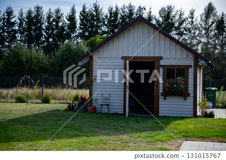 A Charming Wooden Garden Shed Enclosed and Surrounded by Lush Green Natures Beauty A Charming Wooden Garden Shed Enclosed and Surrounded by Lush Green Natures Beauty 131015767