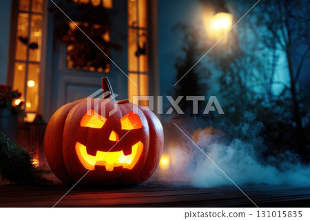 A Spooky Halloween Pumpkin with a Glowing Face Illuminated in the Evening Light of Fall 131015835
