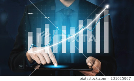 Business Growth and Financial Success Concept: Professional Hand Gestures on Digital Tablet with Graphs and Charts in Background for Strategy and Planning Copula 131015967