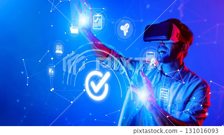 Young man using virtual reality headset to interact with digital icons and graphics, exploring technology trends, innovation, and futuristic experiences. Raster 131016093