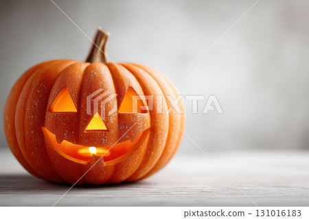 A Cheerful Halloween Pumpkin with a Brightly Illuminated Face and Sparkling Glitter A Cheerful Halloween Pumpkin with a Brightly Illuminated Face and Sparkling Glitter 131016183