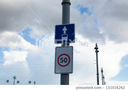 Road sign indicating bus lane with arrow pointing forward, well as speed limit sign of 50 km in h. These signs are common in urban areas to regulate bus traffic and ensure safe driving speeds on road Road sign indicating bus lane with arrow pointing forward, well as speed limit sign of 50 km in h. These signs are common in urban areas to regulate bus traffic and ensure safe driving speeds on road 131016262
