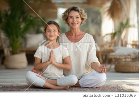 Enjoying a Peaceful and Relaxing Yoga Session at Home with Mother and Daughter Together Enjoying a Peaceful and Relaxing Yoga Session at Home with Mother and Daughter Together 131016369