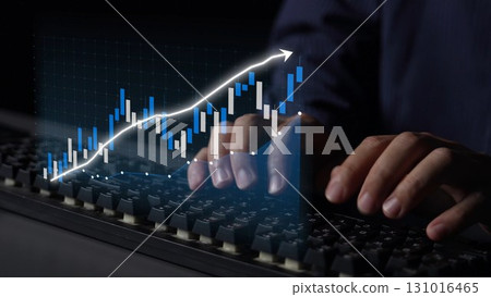 Hands Typing on Keyboard with Stock Market Chart and Financial Data in Background for Business and Trading Concept Copula 131016465