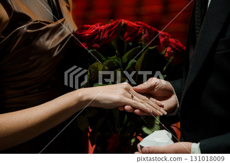 Romantic Proposal with Red Roses: Couple Exchange Rings, Dark Luxury Setting, Elegant Attire, Dramatic Lighting, Valentines Day Engagement Romantic Proposal with Red Roses: Couple Exchange Rings, Dark Luxury Setting, Elegant Attire, Dramatic Lighting, Valentines Day Engagement 131018009