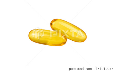 Yellow capsules of cod liver oil supplement on a white background. 131019057