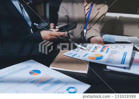 Close up high angle Asian businesswoman working with her coworker in meeting room 131019389