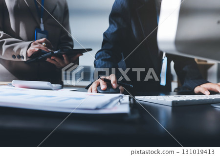 Close up high angle Asian businesswoman working with her coworker in meeting room 131019413