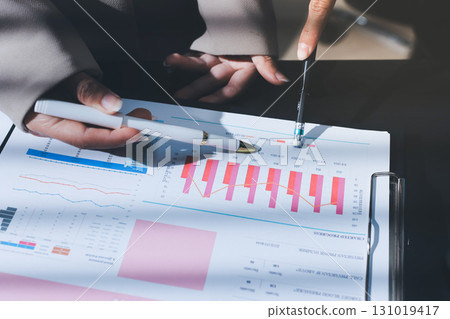 Close up high angle Asian businesswoman working with her coworker in meeting room 131019417
