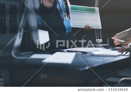 Close up high angle Asian businesswoman working with her coworker in meeting room 131019420