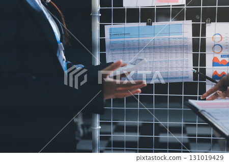 Close up high angle Asian businesswoman working with her coworker in meeting room 131019429