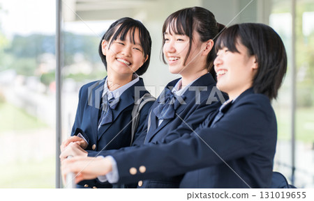 Smiling junior high and high school students chatting with friends after school 131019655