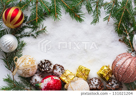 Christmas frame centered around fir tree branches and leaves 131021204