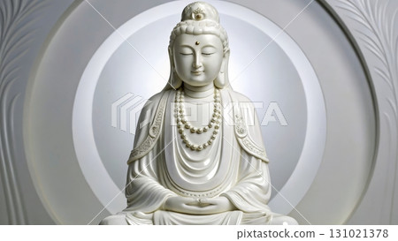 Statue of serene Buddha figure surrounded by soft light in a tranquil setting 131021378