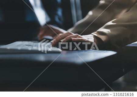Close up high angle Asian businesswoman working with her coworker in meeting room 131021616