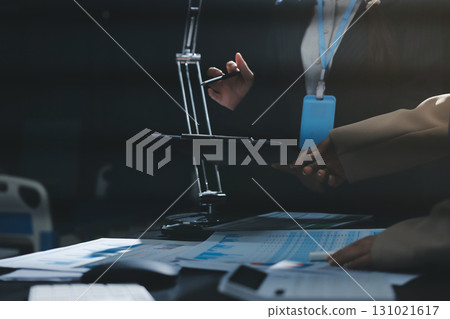 Close up high angle Asian businesswoman working with her coworker in meeting room Close up high angle Asian businesswoman working with her coworker in meeting room 131021617