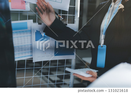 Close up high angle Asian businesswoman working with her coworker in meeting room Close up high angle Asian businesswoman working with her coworker in meeting room 131021618