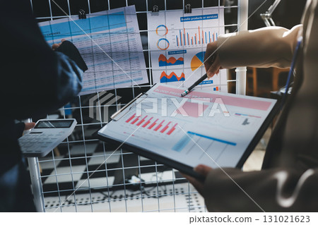 Close up high angle Asian businesswoman working with her coworker in meeting room Close up high angle Asian businesswoman working with her coworker in meeting room 131021623