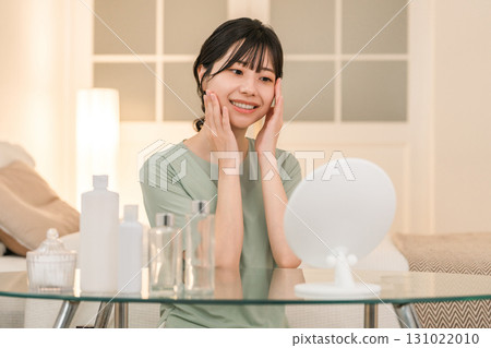 Young Asian woman doing skin care and night care before going to bed at night Young Asian woman doing skin care and night care before going to bed at night 131022010