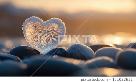 Heart shape ice crystal stone pebble beach sunset golden light romantic symbol love nature outdoor rock formation smooth surface winter frost 131022632