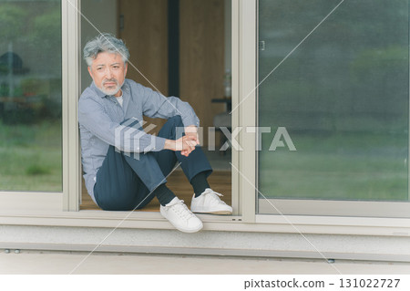 Senior men looking out the window 131022727