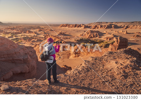 A Stunning Desert Landscape Featuring a Photographer at Sunrise 131023380