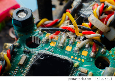 A close-up macro shot of the flight controller of a self-assembled drone built on a carbon fiber frame with exposed electronics. A close-up macro shot of the flight controller of a self-assembled drone built on a carbon fiber frame with exposed electronics. 131023891