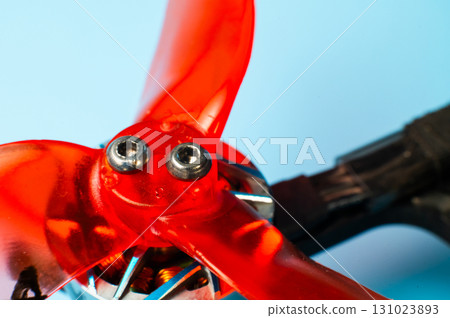 A close-up of a self-assembled drone propeller mounted on a carbon fiber frame with exposed electronics. DIY assembly of unmanned aerial vehicles for a wide range of applications. A close-up of a self-assembled drone propeller mounted on a carbon fiber frame with exposed electronics. DIY assembly of unmanned aerial vehicles for a wide range of applications. 131023893