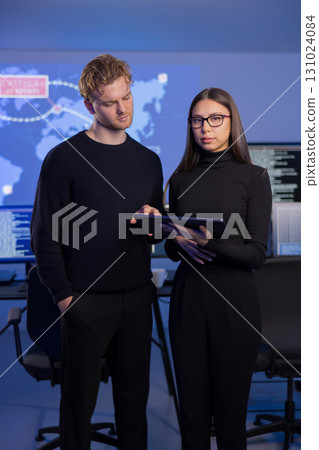 Professional analysts investigate cybersecurity incidents in advanced control room environment 131024084