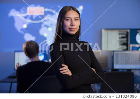 Professional Female Analyst Working in a Security Operations Center with Digital Displays 131024090