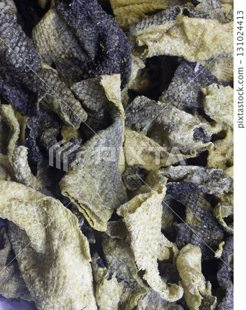 Crispy salted fried salmon skin at thai street food market 131024413