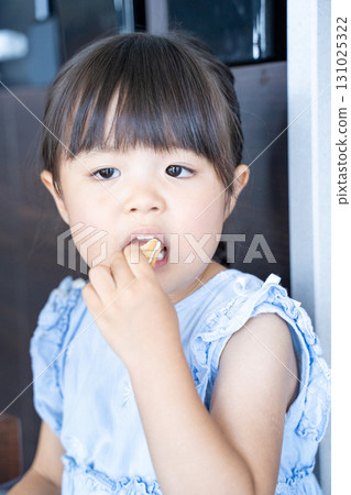 Girl eating sweets 131025322