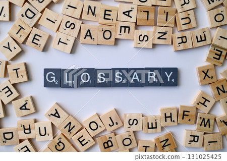 Glossary word in wooden cube blocks, alphabetical dictionary concept, collection of terms and definitions, education and reference idea 131025425