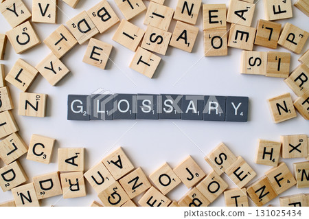 Glossary word in wooden cube blocks, alphabetical dictionary concept, collection of terms and definitions, education and reference idea 131025434