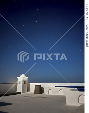 Starry night view from a white house roof in Djerba, Tunisia showcasing a peaceful atmosphere and Starry night view from a white house roof in Djerba, Tunisia showcasing a peaceful atmosphere and 131026167