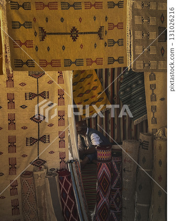 Toudjane in Tunisia showcases vibrant artisan carpets in a cozy market setting with intricate 131026216