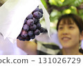 A woman enjoying grape picking (Pione) 131026729