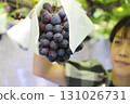 A woman enjoying grape picking (Pione) 131026731