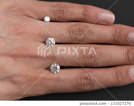 Three diamond rings are shown, with the middle one being the largest 131027276