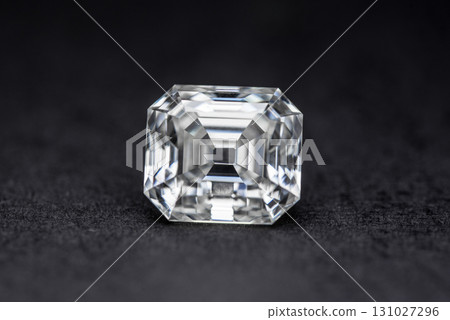 A white diamond is sitting on a black surface 131027296